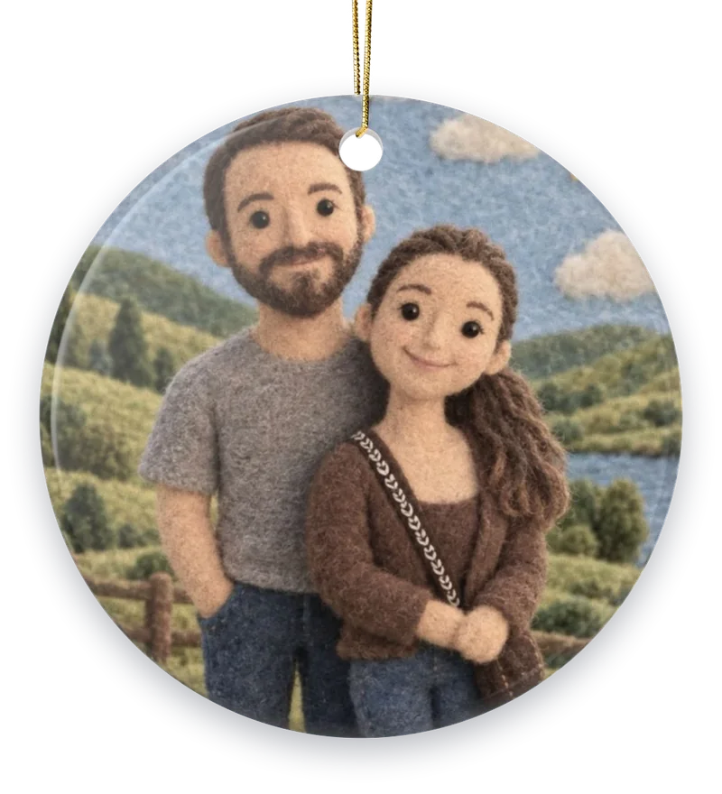 A couple as needle-felted wool figures in a green valley, on a round ceramic ornament