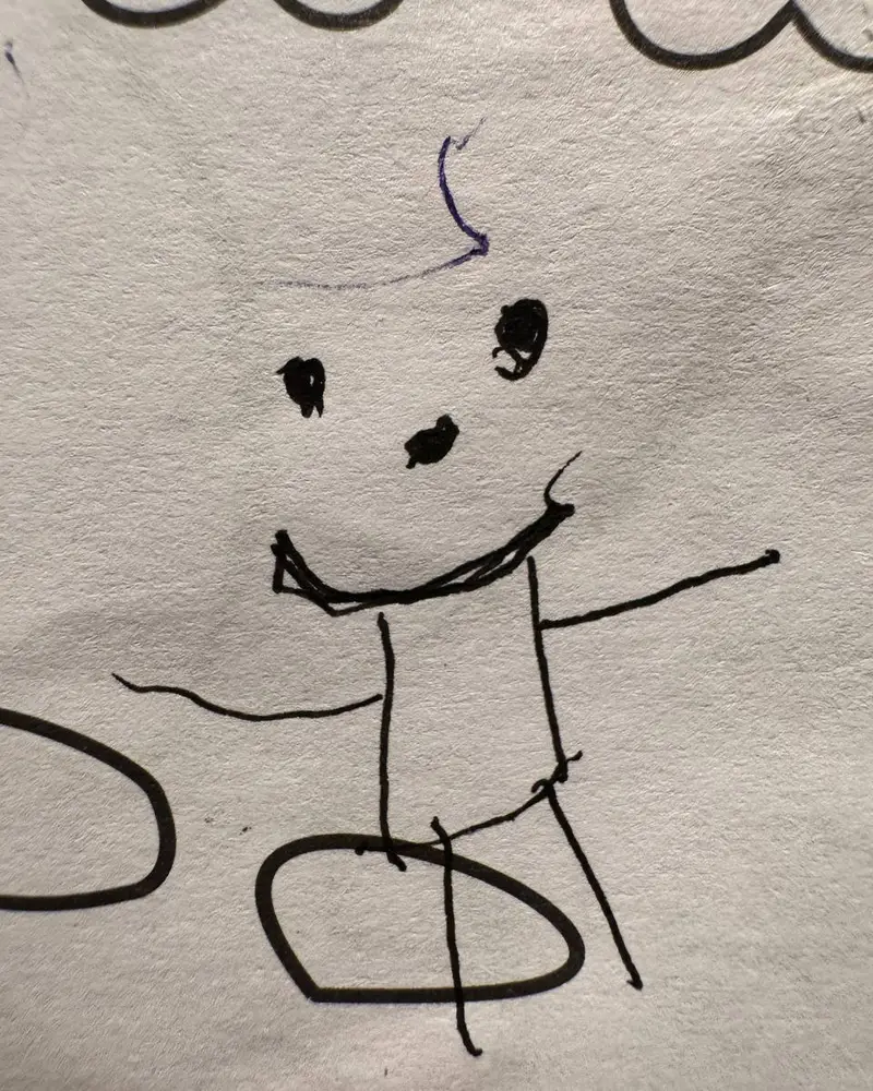 A child's marker drawing of a smiling stick figure with outstretched arms