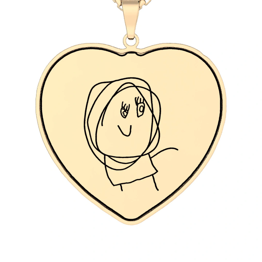 A child's drawing of a smiling woman with big scribbled hair, printed in black line on a heart-shaped gold pendant