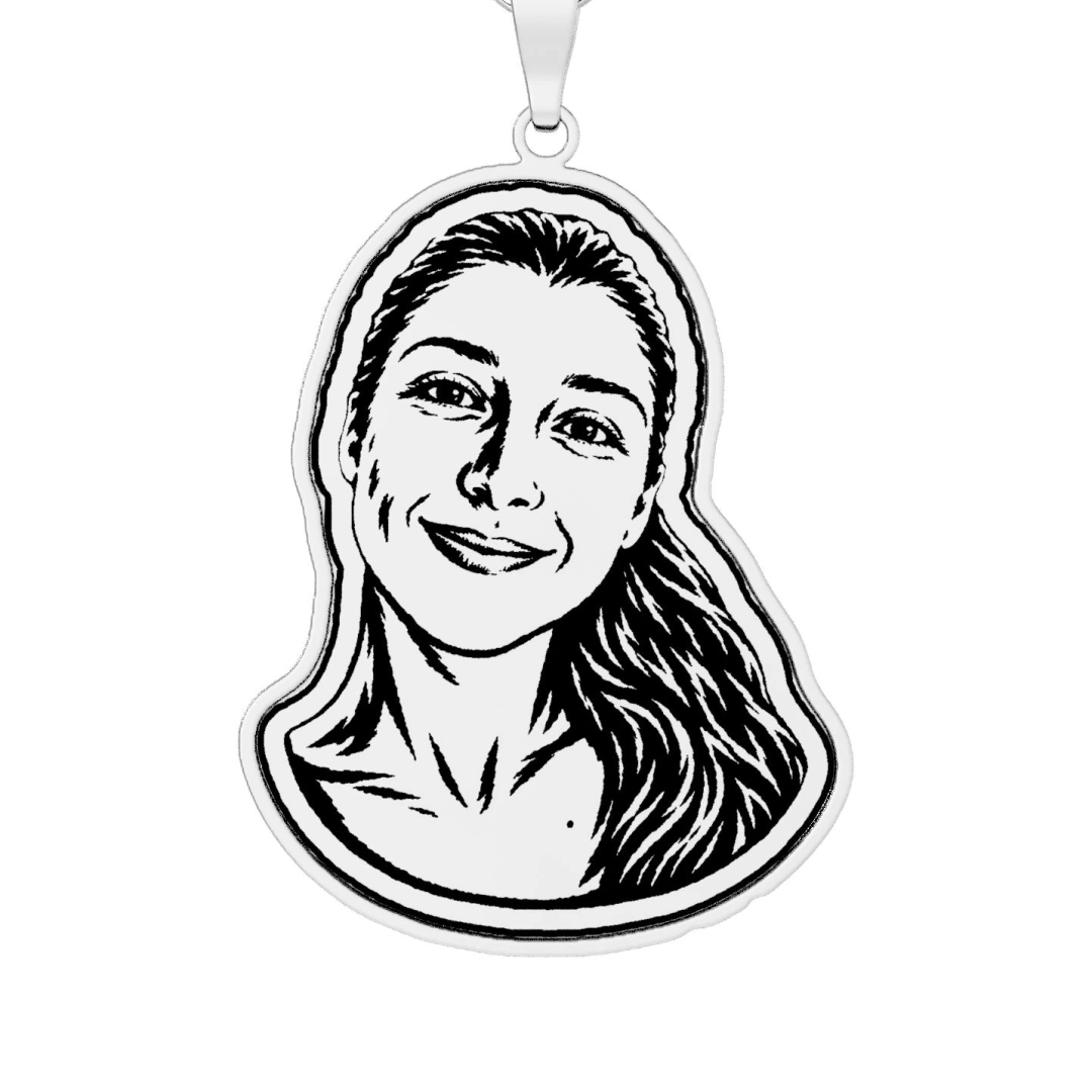 A woman’s face cut as a linocut print, printed in black line on a sterling silver pendant cut to its outline