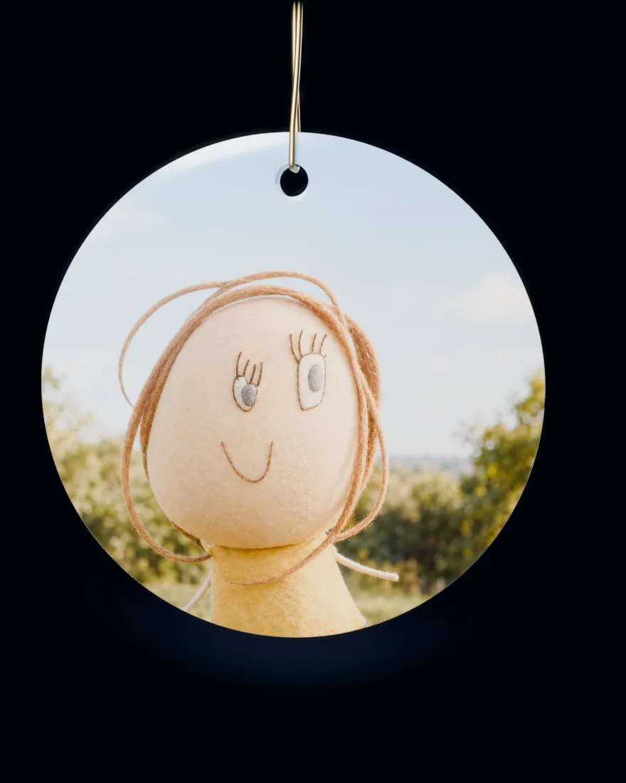 Children’s drawings made real, one after another, printed on a round ceramic Christmas ornament